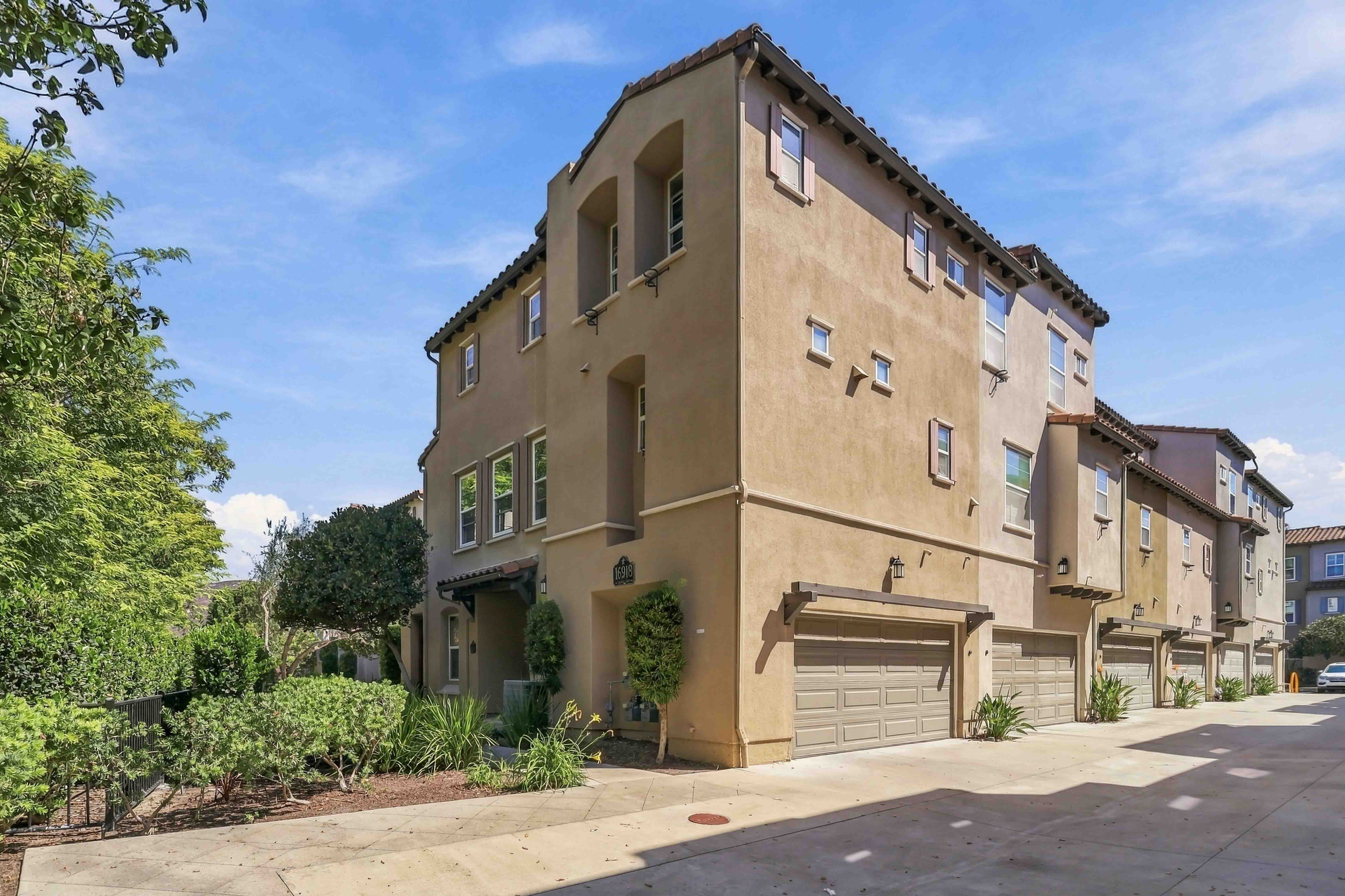 Front exterior of 16918 Vasquez Way #73, a Spanish Mediterranean corner townhome in 4S Ranch, 92127.