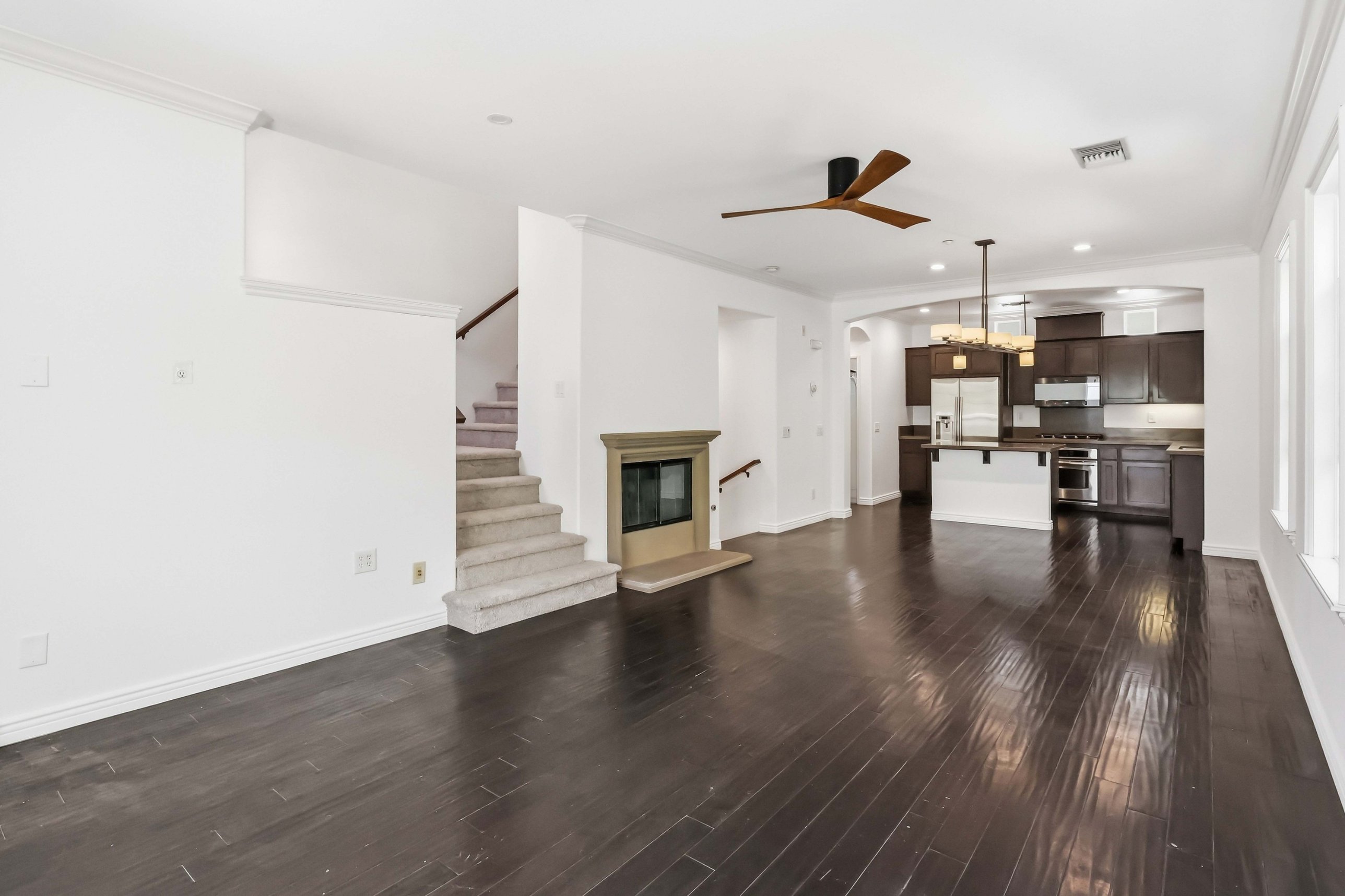 Main living level with gas fireplace and sliding door to balcony.
