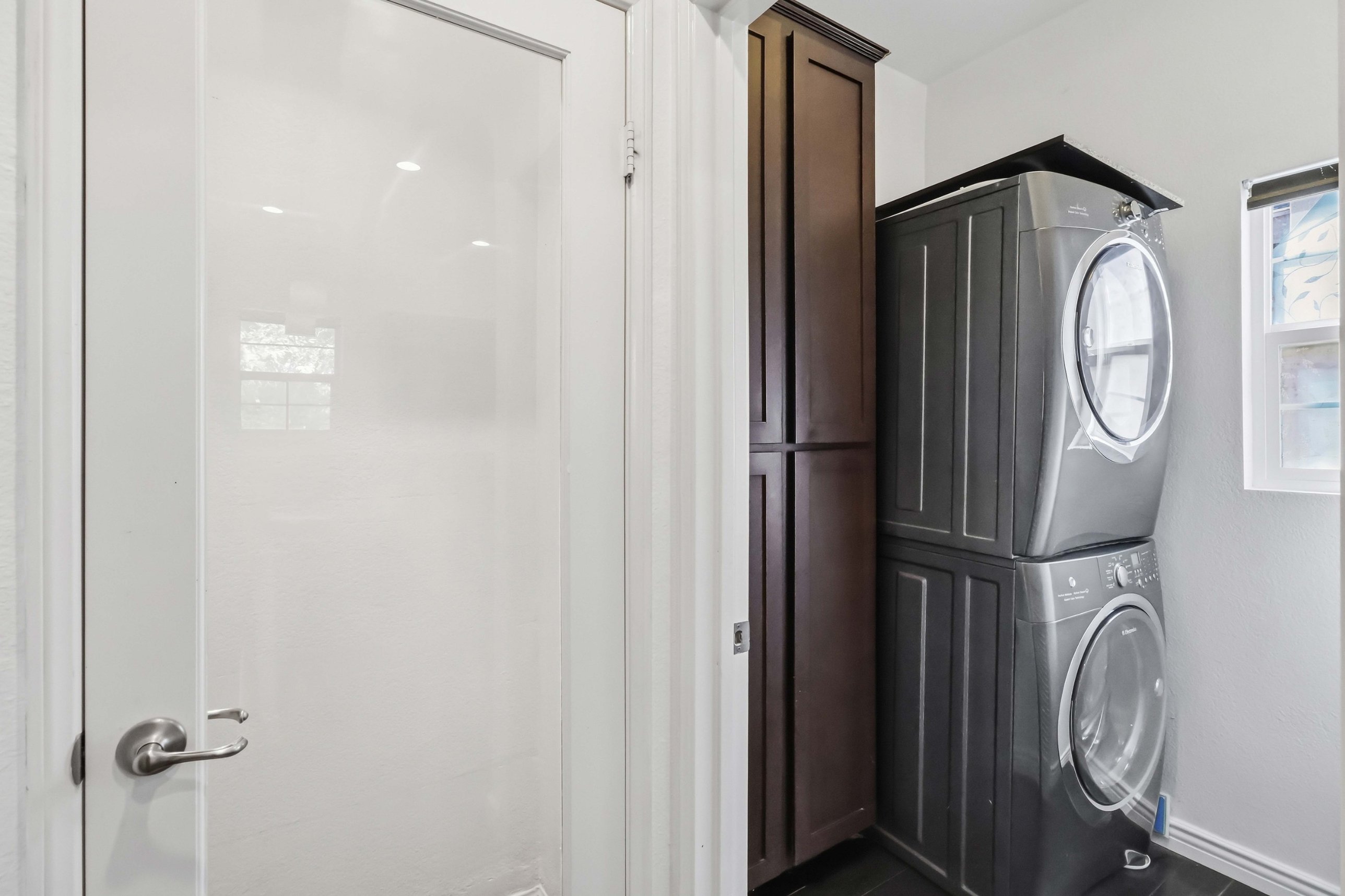 Kitchen detail showing stainless appliances and quartz counters.