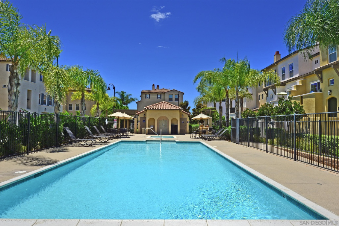 Community pool view with the clubhouse building at the end.